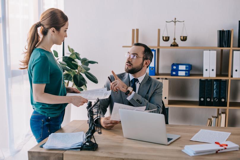 A confident defamation solicitor discussing strategies with a client