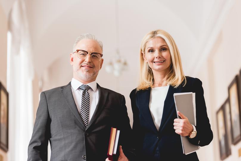 Satisfied client shaking hands with an employment lawyer after successful case resolution