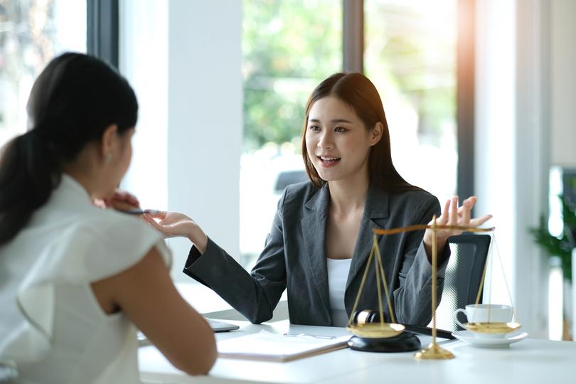 Satisfied client shaking hands with an employment lawyer after successful case resolution